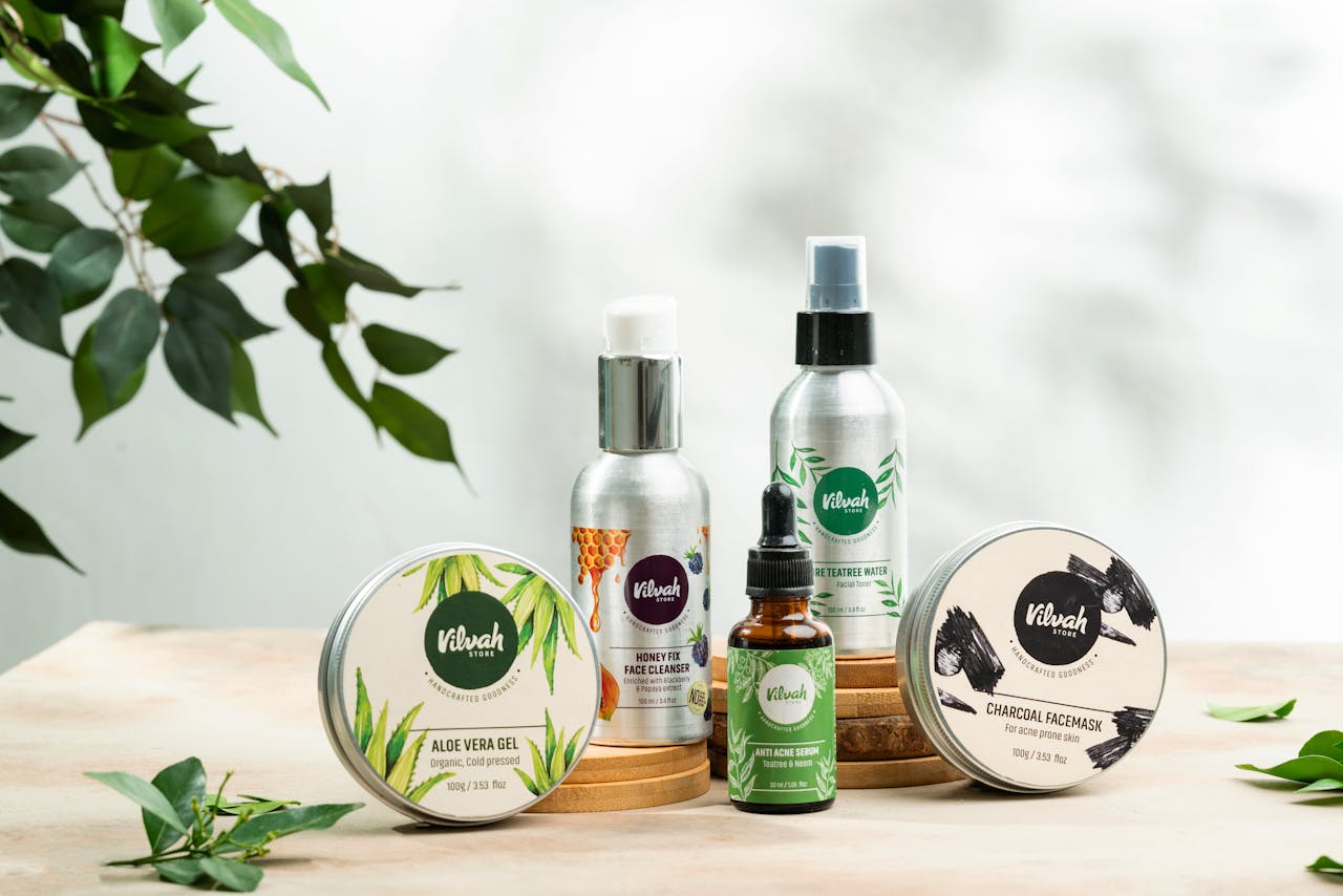 Close-up of natural skincare products including aloe vera gel and charcoal face mask.